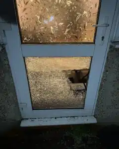 Smashed glass panel on a white uPVC door after a forced break-in in Harrow