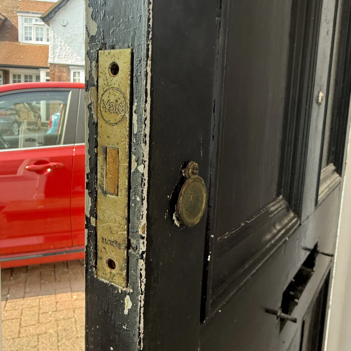 Old worn Yale 3-lever mortice lock on a timber front door before upgrade