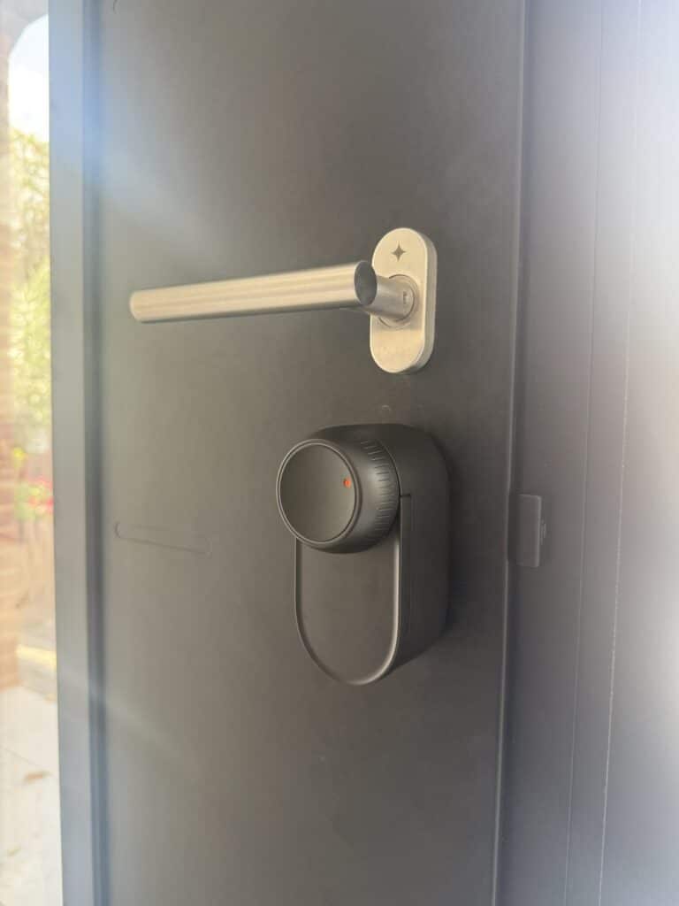 Keyless retrofit smart lock fitted over the cylinder on a composite door in Harrow